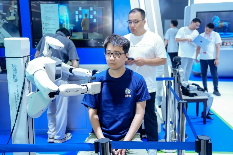 Tencent Xiao Liu robot delivering a massage at WAIC 2026 — Tencent's eldercare humanoid